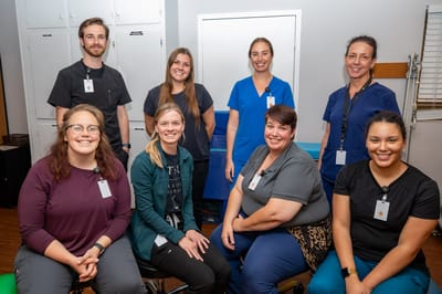Staff members posing in an activity room