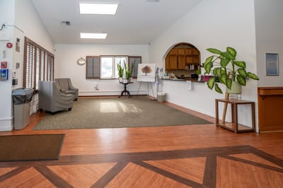 Interior view of a common area with seating and reception desk