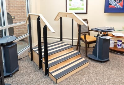 Stairs with railings in an indoor therapy area