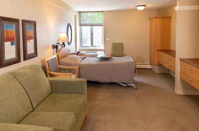A cozy private room with a bed and seating area
