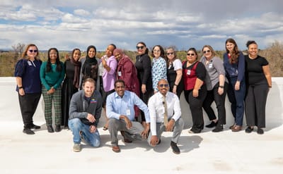 Staff members posing together outdoors