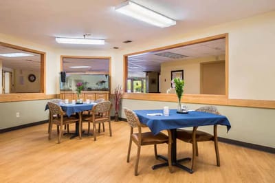 Dining area with two tables and floral centerpieces