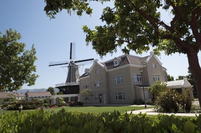 Exterior view of a senior living facility with a windmill