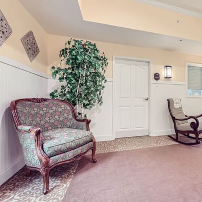 Common area with floral couch and rocking chair