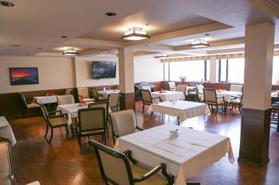 Dining area with tables set for residents
