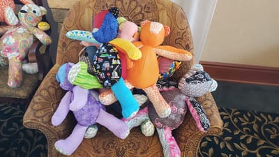 Colorful stuffed animals arranged on a chair