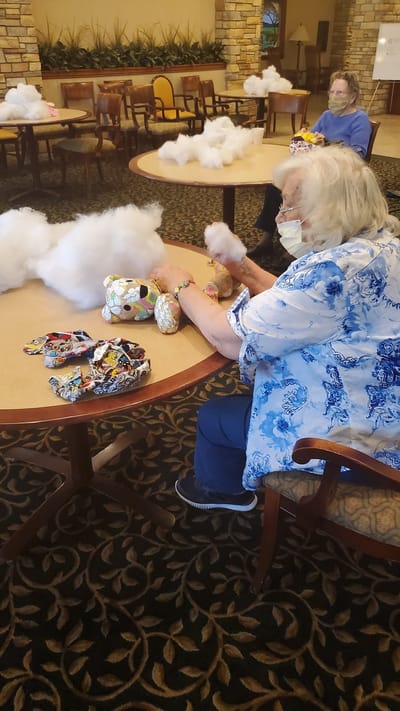 Residents engaging in a craft activity at a communal table