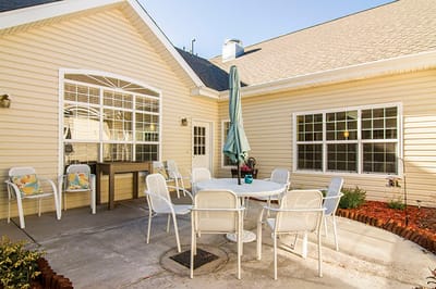 Outdoor patio area with seating and umbrella