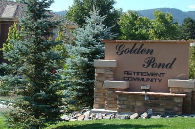 Sign for Golden Pond Retirement Community surrounded by trees