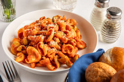 Plate of pasta with cheese and herbs
