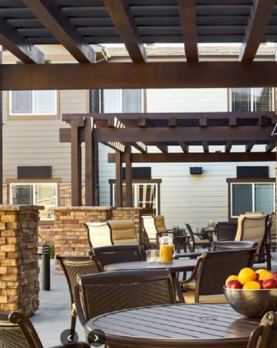 Outdoor seating area with tables and fruit display