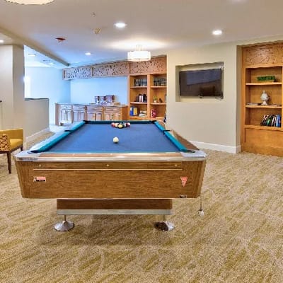 Activity room with a pool table in the facility