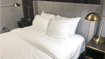A neatly made bed in a modern room setting