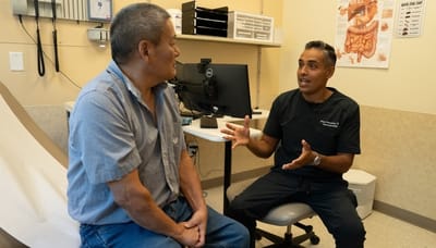 A doctor consulting with a patient in an examination room