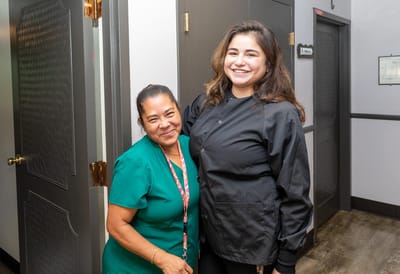Staff member with a resident in a facility hallway