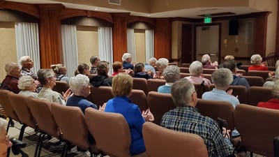 Residents enjoying a performance in a common area