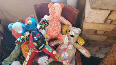 Colorful fabric bears arranged on a chair