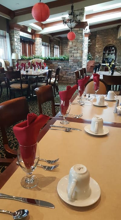 Dining room set with red napkins and glasses
