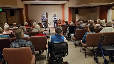 Residents enjoying a live music performance in a common area