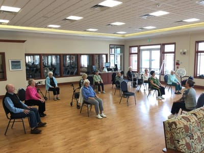 Residents participating in a seated activity in a common area