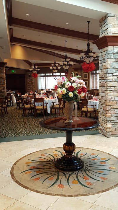 Elegant dining room with floral centerpiece and tables set