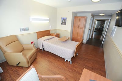 Private resident room with a bed and seating area