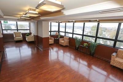 Bright common area with seating and large windows