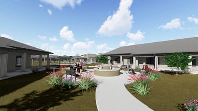 Outdoor garden area with residents and wheelchairs