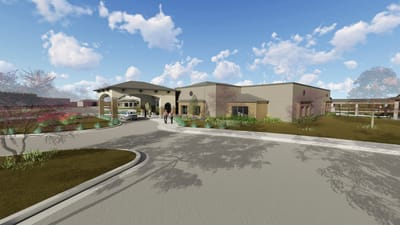 Exterior view of Bluestem Village with residents arriving