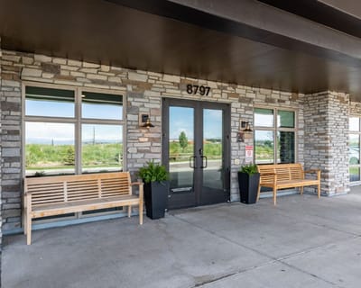 Exterior view of the facility entrance with seating area