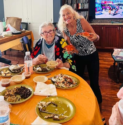 Residents enjoying a meal together with staff