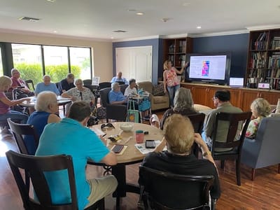 Residents engaged in a presentation in a common area