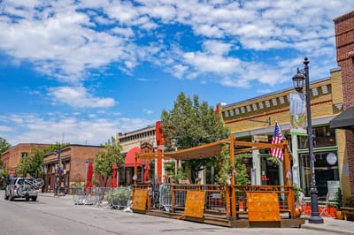 Exterior view of a rustic building with outdoor seating