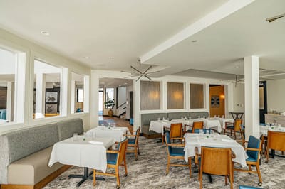 Bright dining area with tables set for residents
