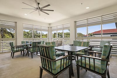 Bright common area with seating and large windows