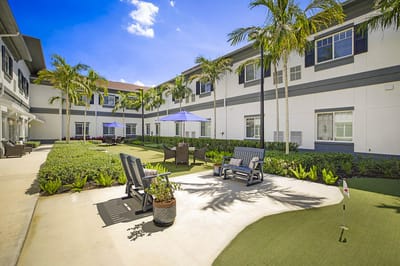 Outdoor seating area with palm trees and umbrellas