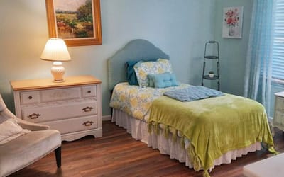 Cozy private resident room with bed and lamp