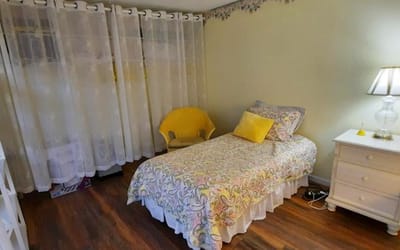 Cozy resident room with bed and chair