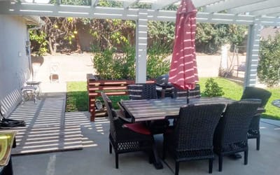 Outdoor patio area with seating and umbrella