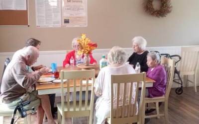 Residents enjoying a meal together in the dining room