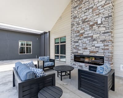 Outdoor seating area with stone fireplace and lounge chairs