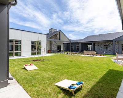 Outdoor courtyard with lawn and seating areas