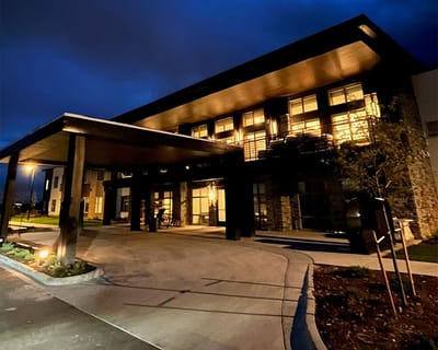 Exterior view of a facility at night with illuminated entrance