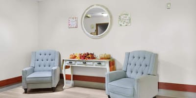 A cozy interior with blue chairs and autumn decor