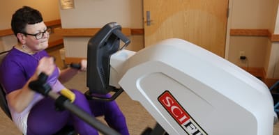 Resident exercising on a fitness machine in the facility