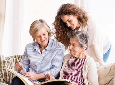 Residents and staff engaging with a photo album