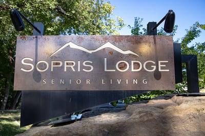 Facility logo sign with mountains in the background