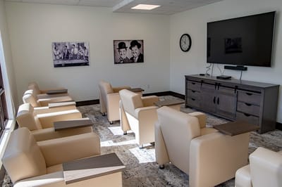 Cozy lounge area with chairs and artwork on the walls