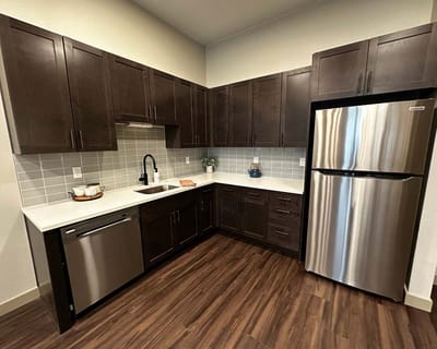 Modern kitchen interior with wooden cabinets and stainless steel appliances