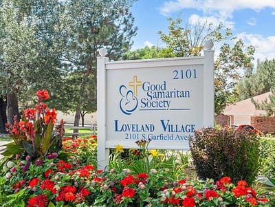 Facility sign with flowers and landscaping